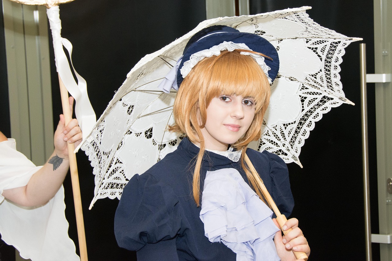 A cosplayer in a lace dress holding a parasol at an event