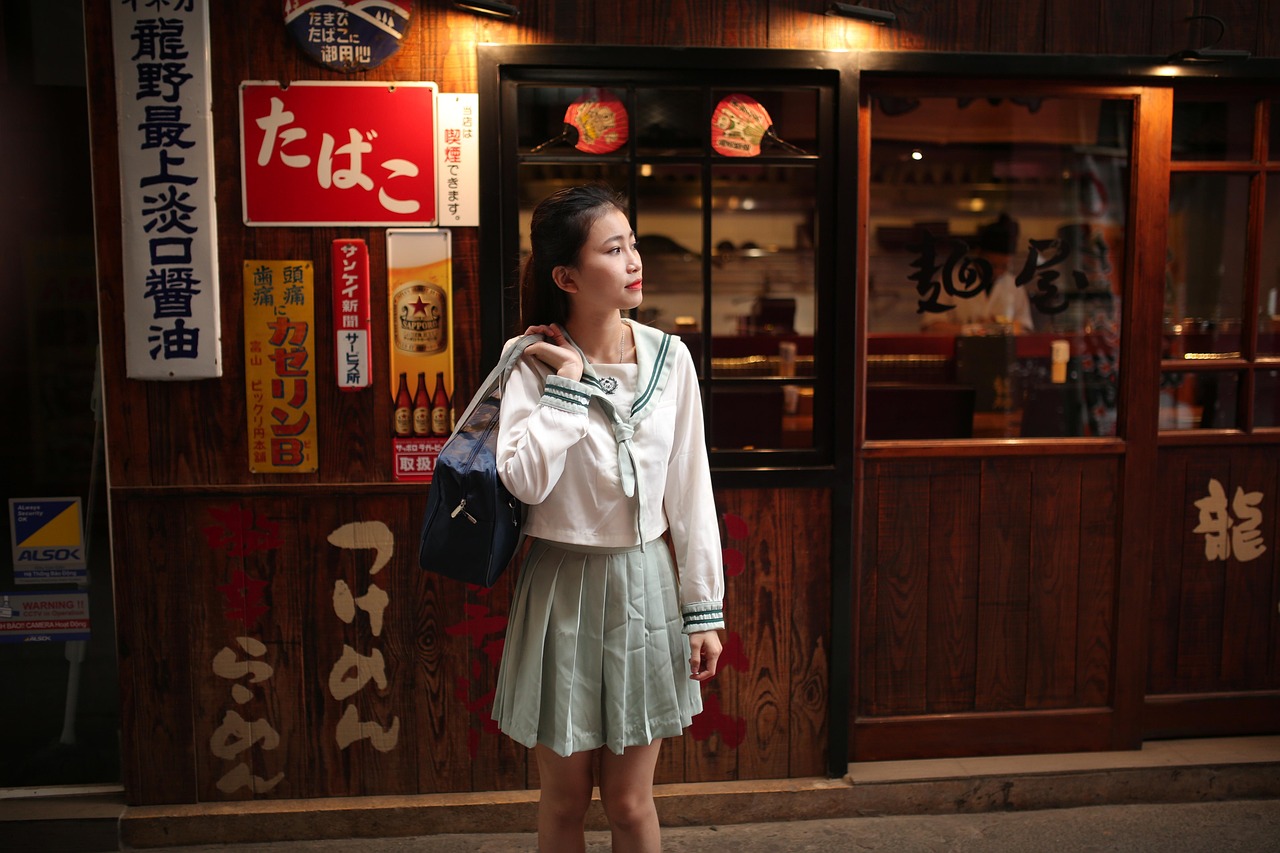 A woman on a street lined with Japanese shop signs