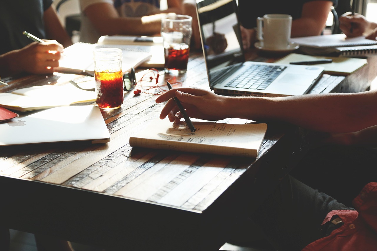 People working together at a table with laptops