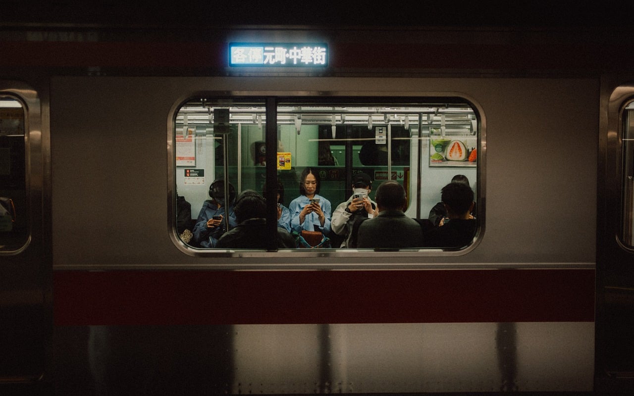 Passengers seen through the window of a Japanese train