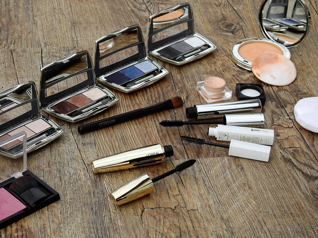 Eyeshadow palettes and makeup products on a table