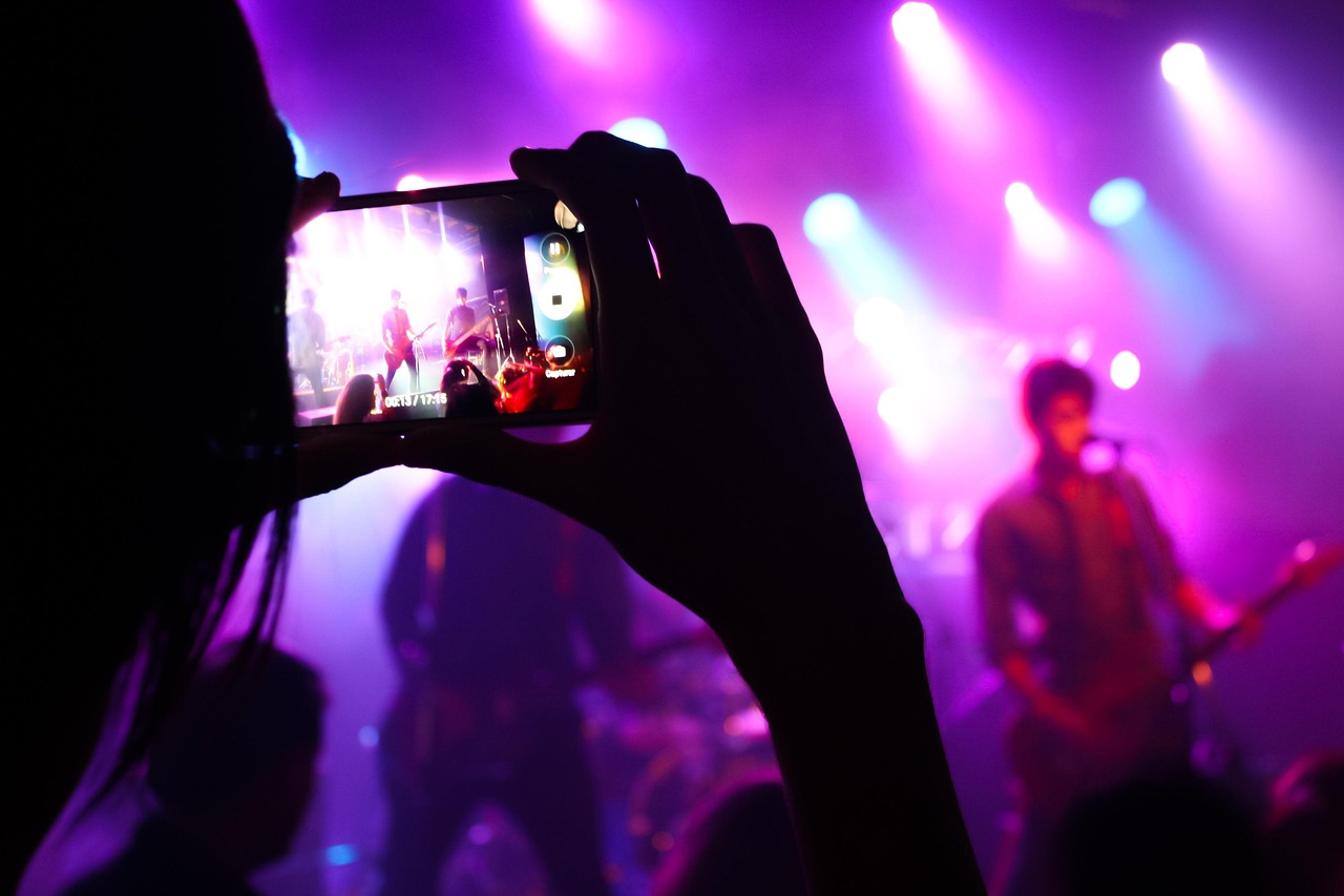 A smartphone recording a live performance on stage