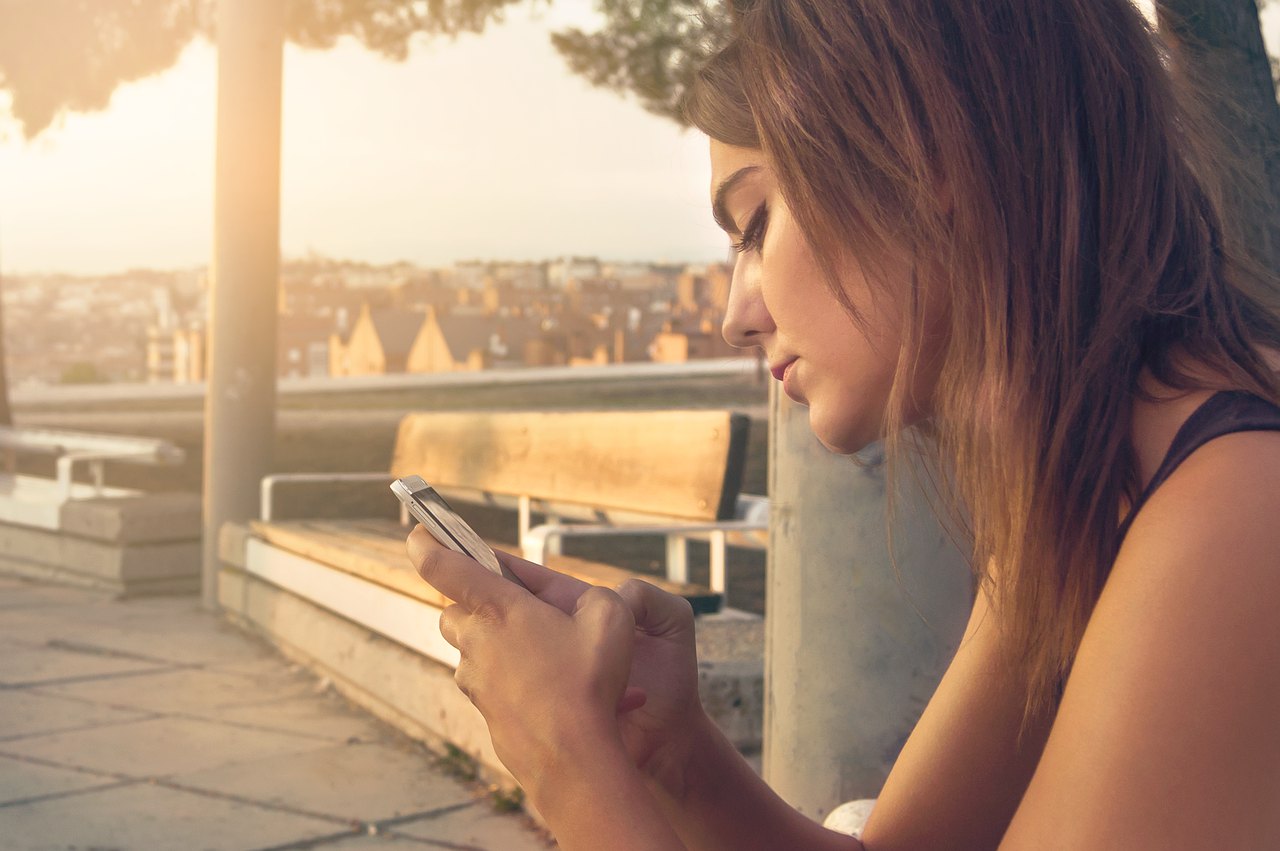 A young woman looking at her smartphone