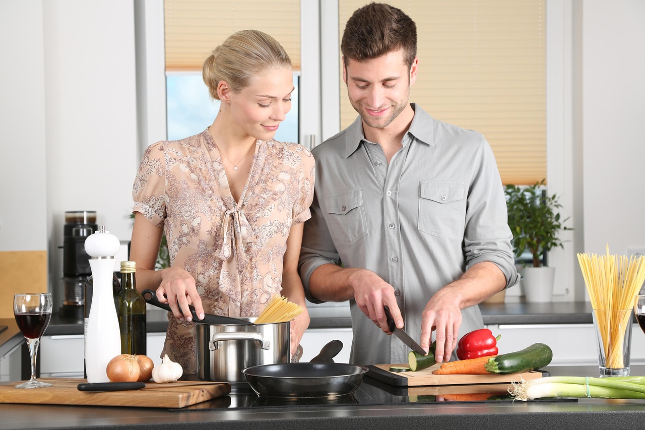 Two people cooking together in a kitchen
