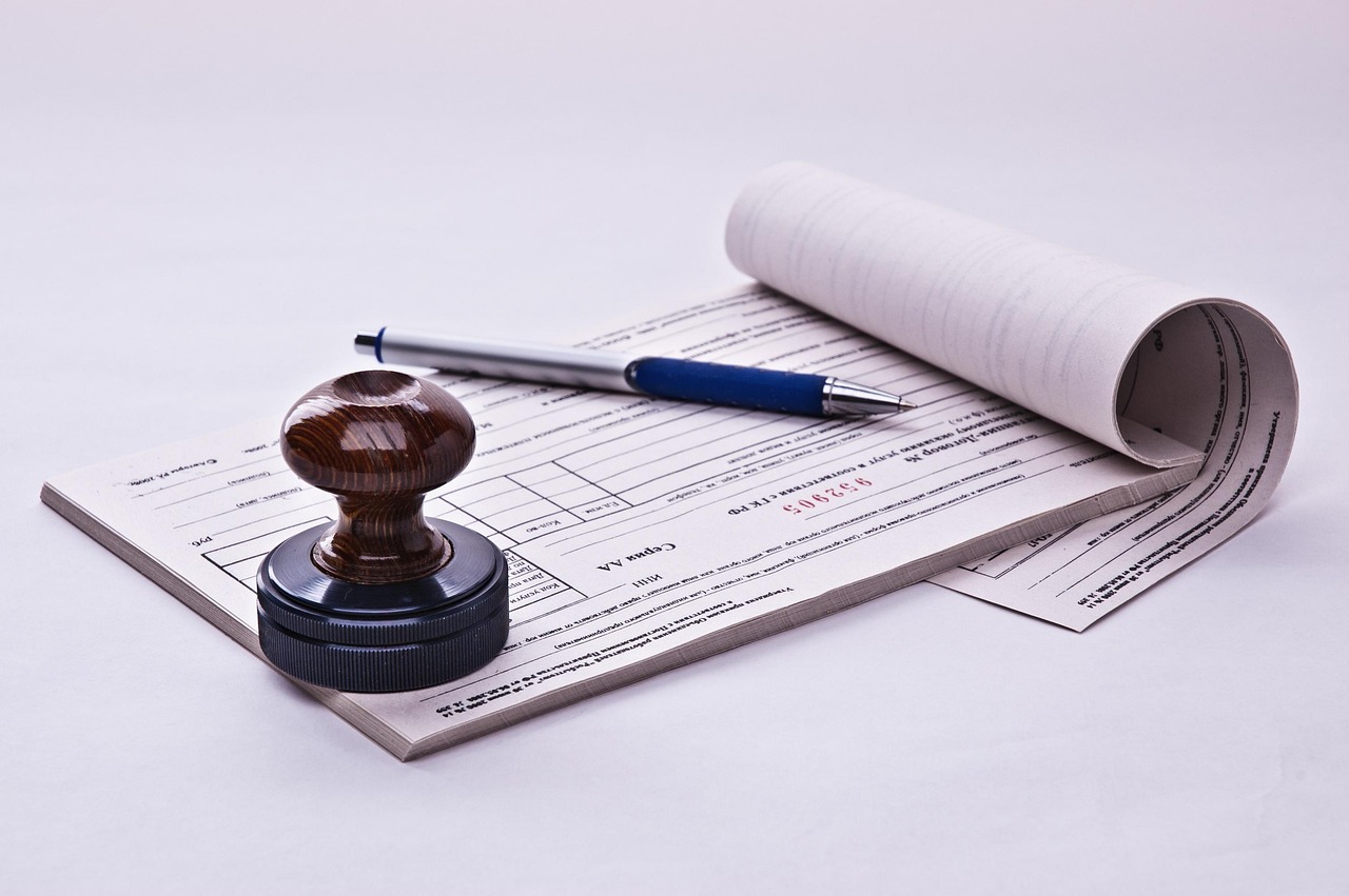 A stamp and pen on business paperwork