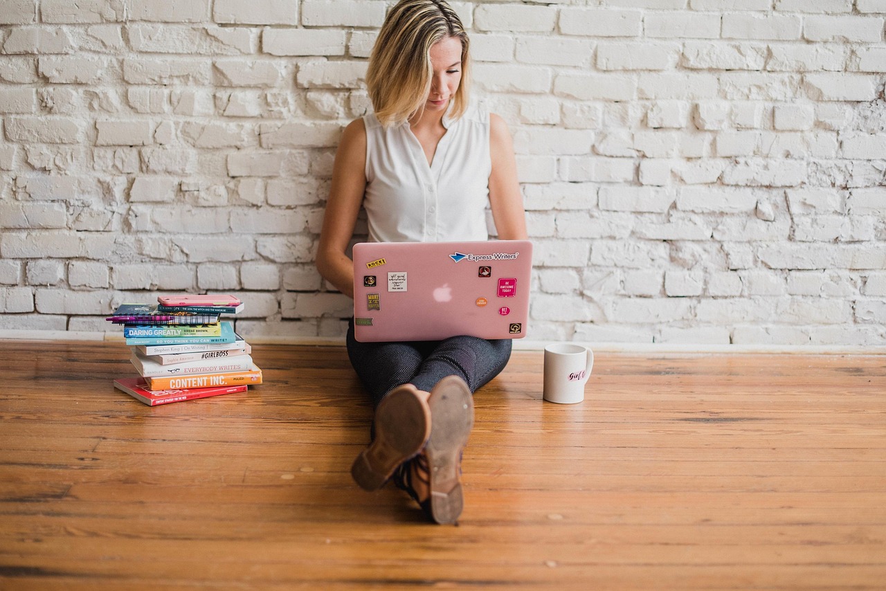 A creator working on a laptop at home