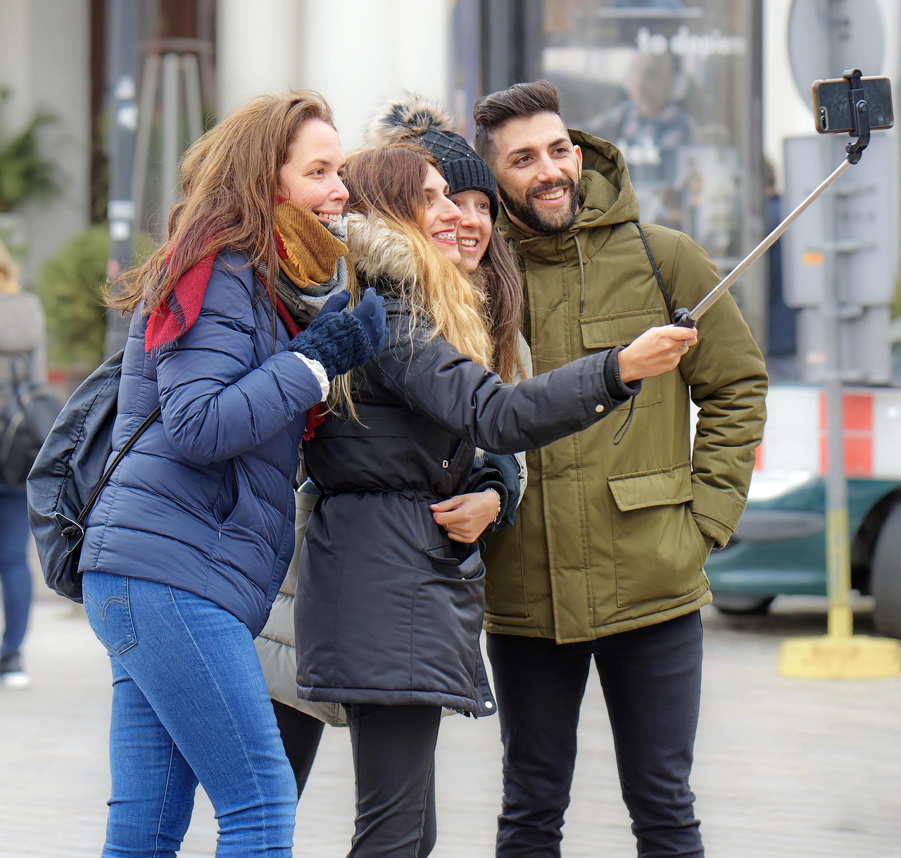 Friends taking a selfie video on a city street